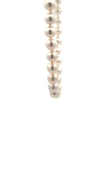 White pearls necklace on a white background