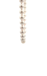 White pearls necklace on a white background