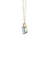 Side view of gold necklace with with an emerald-cut aquamarine and diamond accents.