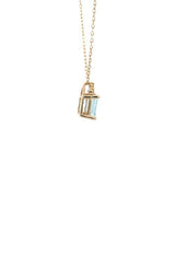 Side view of gold necklace with with an emerald-cut aquamarine and diamond accents.