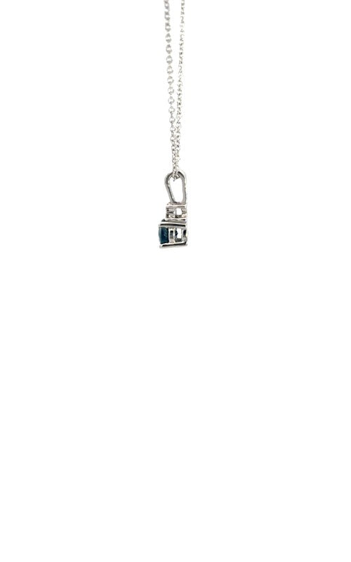 Side view silver necklace with a teardrop-shaped blue sapphire pendant