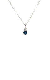 Silver necklace with a teardrop-shaped blue sapphire pendant