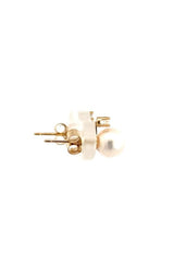 Side view of pair of gold pearl stud earrings.