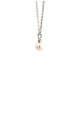 Side view of silver necklace with white pearl pendant with diamond accent