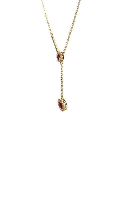 Gold lariat necklace with two round-shaped ruby pendants, each surrounded by a halo of smaller diamonds.