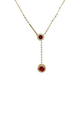 Gold lariat necklace with two round-shaped ruby pendants, each surrounded by a halo of smaller diamonds.