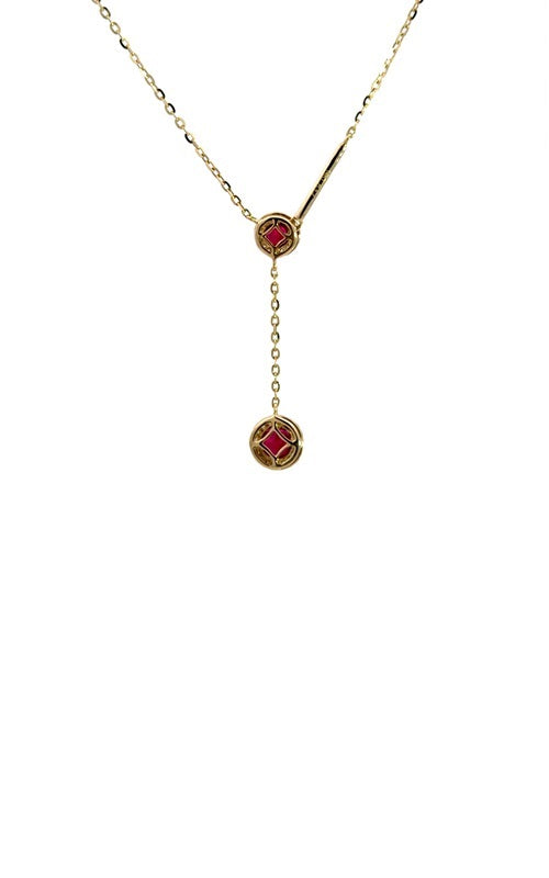 Gold lariat necklace with two round-shaped ruby pendants, each surrounded by a halo of smaller diamonds.