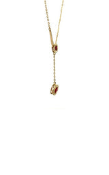 Gold lariat necklace with two round-shaped ruby pendants, each surrounded by a halo of smaller diamonds.