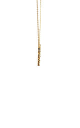 Gold necklace with a circular pendant featuring a geometric design of baguette-cut diamonds.