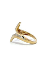 Gold ring with diamond accents, featuring a curved, open-ended design.