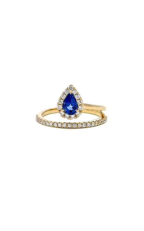 Gold ring with a split shank design, featuring a cushion-cut sapphire surrounded by a halo of smaller diamonds.