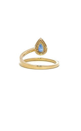 Gold ring with a split shank design, featuring a cushion-cut sapphire surrounded by a halo of smaller diamonds.