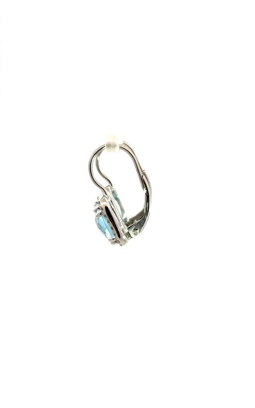 Side view of silver clip-on earrings with a cushion-cut blue topaz center stone and a halo of smaller clear stones.