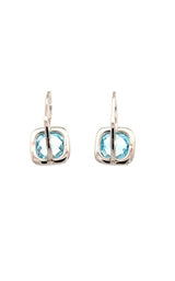 Back view view of silver clip-on earrings with a cushion-cut blue topaz center stone and a halo of smaller clear stones.