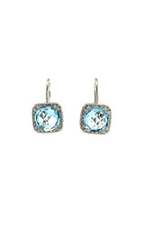 Front view of silver clip-on earrings with a cushion-cut blue topaz center stone and a halo of smaller clear stones.