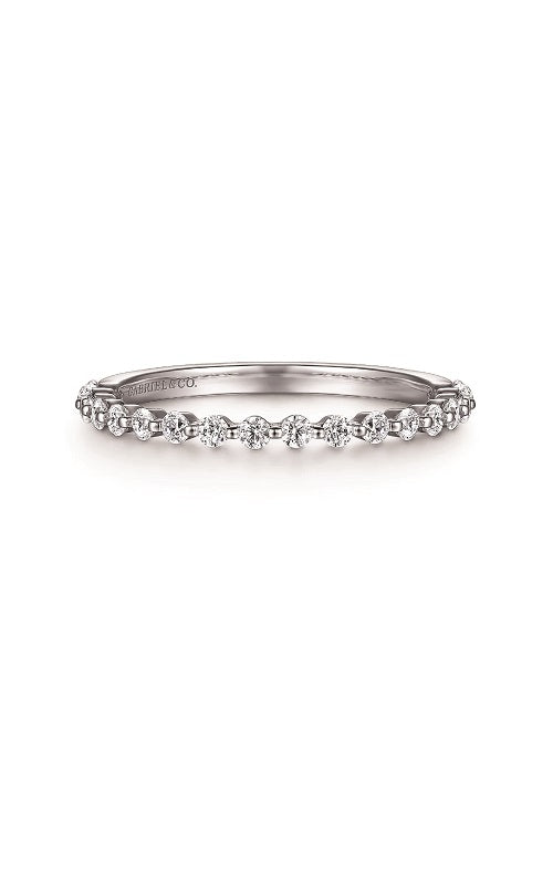 Thin silver wedding band featuring a shared prong setting with round diamonds.