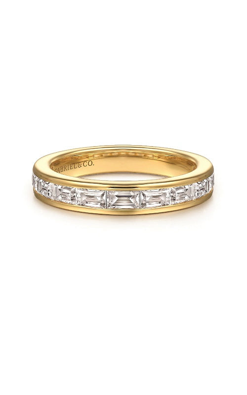 Gold ring with a baguette diamond in channel setting on a white background.