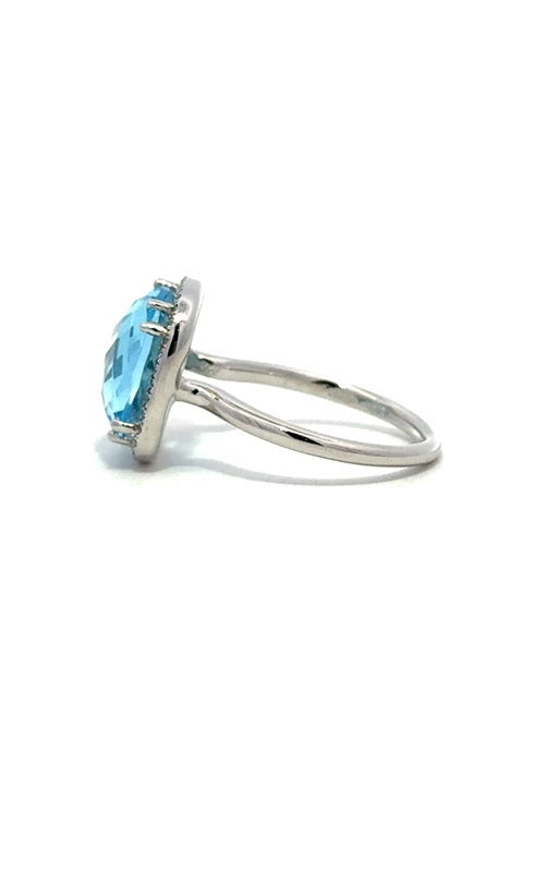 Side view of a silver ring with a large, oval-shaped blue topaz gemstone